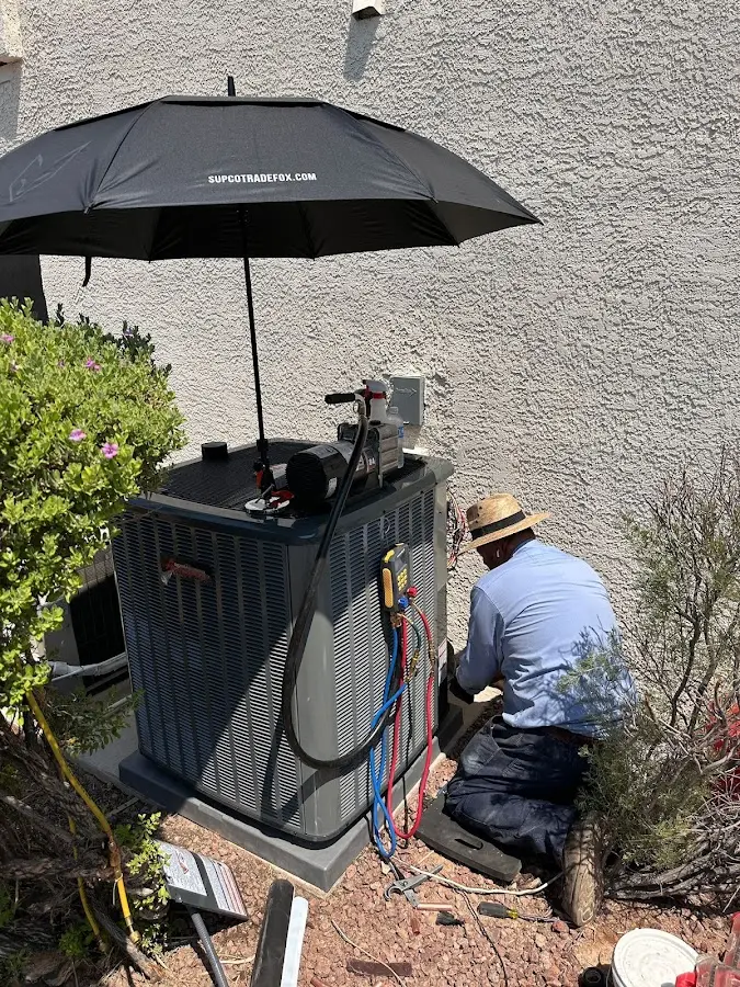 HVAC technician performing outdoor AC maintenance in Arnold